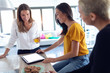 © nenetus - Three young entrepreneur women taking a break and using digital tablet in the office.