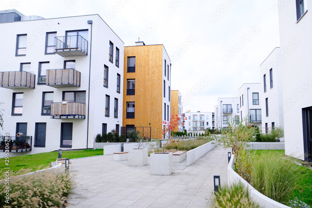 Sidewalk in a cozy courtyard of modern apartment buildings condo with white walls. - obrazy, fototapety, plakaty 