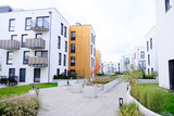 Fototapeta Sypialnia - Sidewalk in a cozy courtyard of modern apartment buildings condo with white walls.