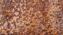 Close Up Background Texture Of Weathered, Rusty, And Pitted Metal