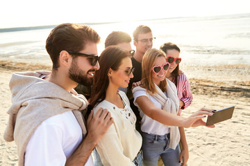 Sticker - friendship, leisure and people concept - group of happy friends taking selfie by smartphone in summer