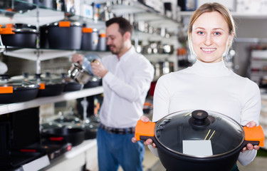 Wall Mural - Female customer examining crockery