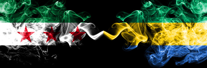 Syrian Arab Republic vs Gabon, Gabonese smoke flags placed side by side. Thick colored silky smoke flags of Syria opposition and Gabon, Gabonese