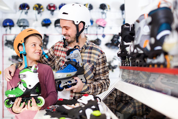 Wall Mural - Adult helping his son to choose rollers.