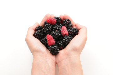 Berries kept in hands isolated on white background.