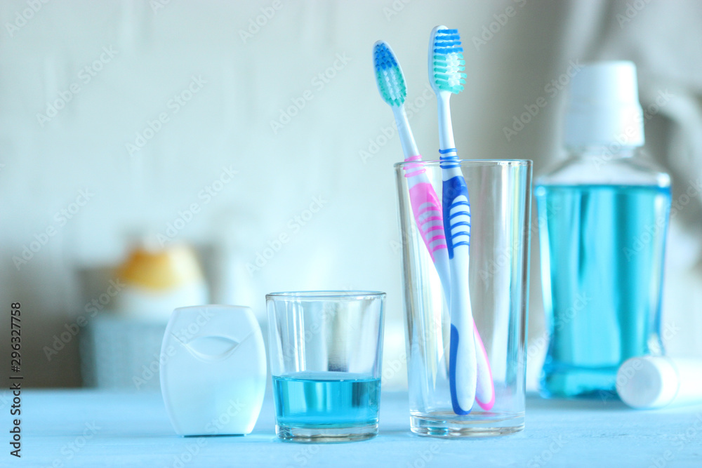Toothbrushes and oral cleaners on the table. - obrazy, fototapety, plakaty 