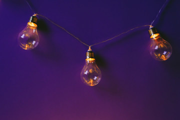 Beautiful illuminated festive light bulbs garland close up