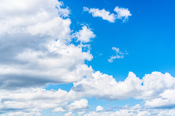 Blue sky background with clouds, copy space for text.