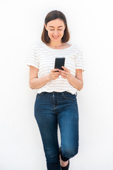 Wall Mural - older woman holding mobile phone by white background