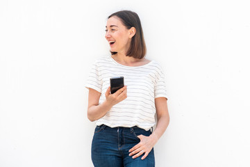 happy middle aged woman holding mobile phone by white background