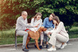 © hetmanstock2 - Family in a summer park. People walking with a dog. Parents with a two daughters