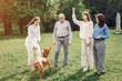 © hetmanstock2 - Family in a summer park. People walking with a dog. Parents with a two daughters