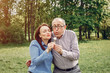 © hetmanstock2 - Couple in a forest. Adult pair walking. Lady in a blue shirt