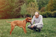 © hetmanstock2 - Hundsome man in a park. Adult male with cute dog