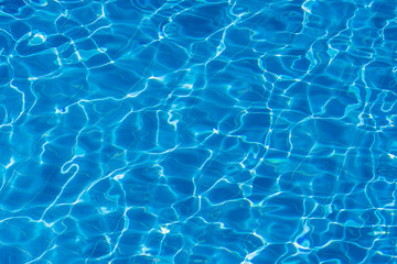  Water ripples on blue tiled swimming pool background. Top view
