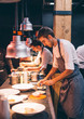 © Jes˙s Martinez/Westend61 - Chef serving food on plates in the kitchen, of a restaurant