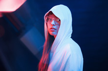 Modern Look Of Youth. Studio Shot In Dark Studio With Neon Light. Portrait Of Young Girl