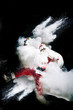 © Oscar Carrascosa Martinez/Westend61 - Santa Claus with exploding snow bomb against black background