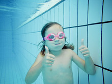 Underwater Portrait Of A Girl With Thumbs Up