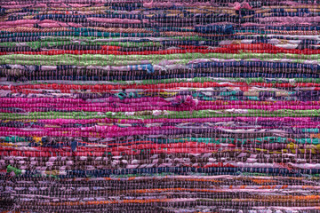 cloth, typically produced by weaving or knitting textile fibers. background and texture red old fabr