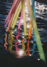 Selective Focus View Of Colorful Straws Placed In Water