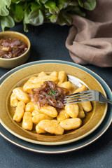 Canvas Print - Homemade Gnocchi - dumplings made from potato and pumpkin, with caramelised onion and butter sauce.