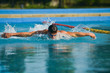 © xpabli - Swimmer standing next to a pool on a sunny morning