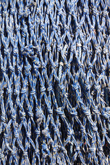 Close-up full frame view of a heavy fishing net used by trawlers on the ocean