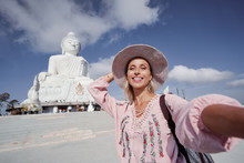 Traveling By Thailand. Pretty Young Woman In Hat Taking Selfie In The Big Buddha Temple, Famous Phuket Sightseeing.