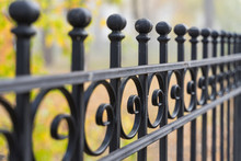 Beautiful Decorative Cast Iron Wrought Fence With Artistic Forging. Metal Guardrail Close Up.