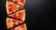© Vladislav Noseek - Pepperoni pizza slice on black slate background. Banner. Copy space. Pizza restaurant menu
