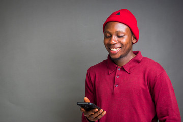 young african man feeling happy with what he saw on his phone.