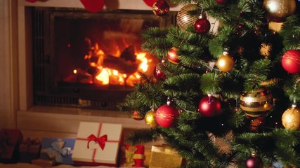 Wall Mural - 4k video of big heap of gifts and present next to burning fireplace and glowing Christmas tree in living room on Christmas eve