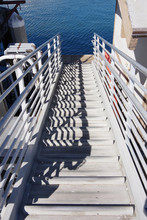 View Down The Stairs From The Pier To A Floating Dock At A Fishing Harbor