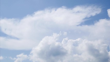 Wall Mural - time lapse white clouds on a blue sky. 4k fluffy white clouds moving during the day time