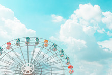 Retro Pastel Colorful Ferris Wheel Of The Amusement Park In The Blue Sky  And Cloud Background.