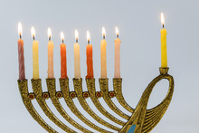 Menorah With Lit Candles In Celebration Of Chanukah. A Symbolic Candle Lighting For The Jewish Holiday
