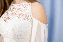 Part Of A White Dress With Lace On A Woman. Beautiful White Dress On The Girls Shoulder