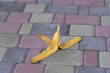 © OlegD - Banana peel was left on the pavement. The danger may slip. If anyone walks on it. Be careful of slippery. Closeup, outdoors