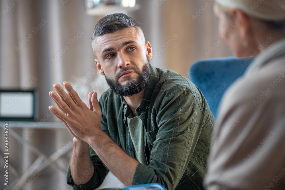 Man looking at psychologist telling him about stress - obrazy, fototapety, plakaty 