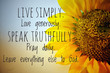 © Maria Marganingsih - Inspirational quote - Live simply, love generously, speak truthfully, pray daily, leave everything else to God.  With background of half big yellow sunflower blossom.