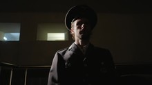 Military Officer Siting In A Dark Room