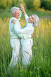 © aletia2011 - Portrait of beautiful senior couple dancing in summer park