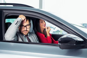 Wall Mural - Young woman applying makeup in car