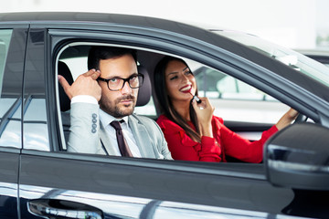 Wall Mural - Young woman applying makeup in car