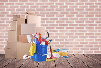 Wall Mural - Cleaning supplies with moving boxes on background