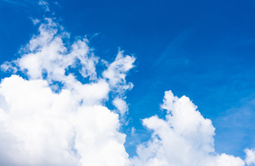 Fluffy bright white clouds with a beautiful clear blue sky ozone and background sunshine in the summer morning.