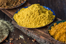 Heaps Of Various Ground Spices On Wooden Background. Georgian Spices, Indian Spices, Arabian Spices. Spice Variety. Herbs And Spices