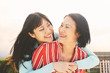 © Alessandro Biascioli - Happy Asian mother and daughter having fun outdoor - Chinese family people spending time together outside - Love, relationship and parenthood lifestyle concept