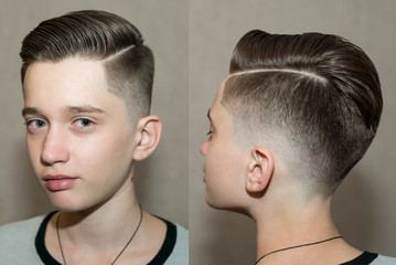 Stylish modern retro haircut side part with mid fade with parting of a school boy guy in a barbershop on a brown background